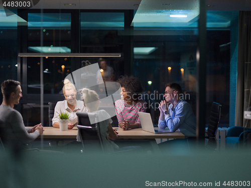 Image of Multiethnic startup business team in night office