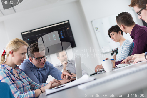 Image of Two Business People Working With laptop in office