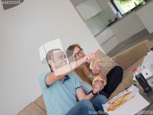 Image of couple eating pizza in their luxury home villa