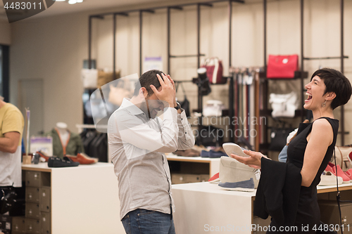 Image of couple chooses shoes At Shoe Store