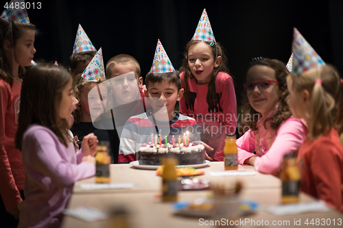 Image of The young boy joyfully celebrating his birthday