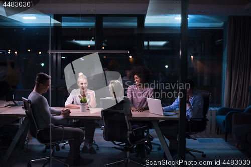 Image of Multiethnic startup business team in night office