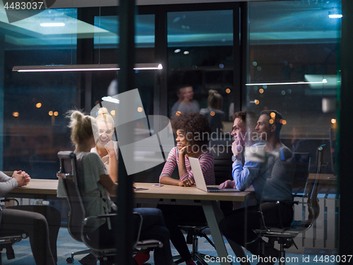 Image of Multiethnic startup business team in night office