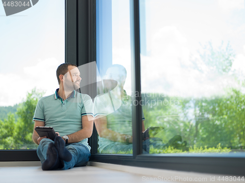 Image of man on the floor enjoying relaxing lifestyle