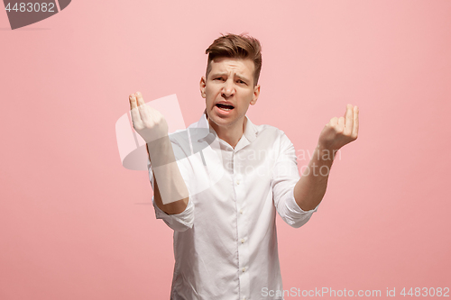 Image of Beautiful male half-length portrait isolated on pink studio backgroud. The young emotional surprised man