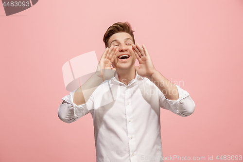 Image of Isolated on pink young casual man shouting at studio