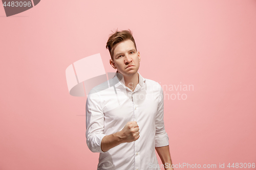 Image of The young emotional angry man screaming on pink studio background