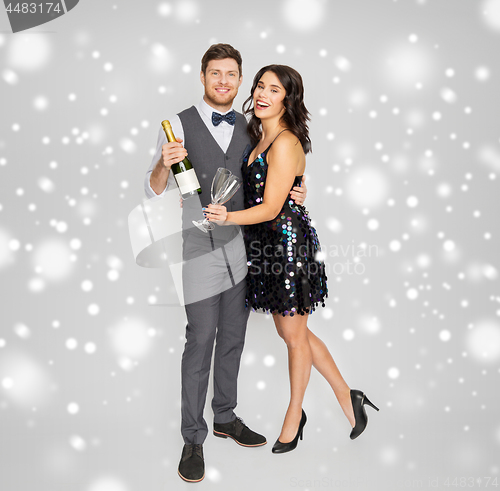 Image of happy couple with champagne celebrating christmas