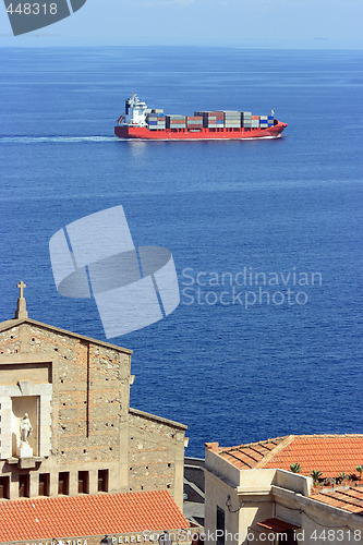 Image of Cantainer cargo ship over Scilla cathedral