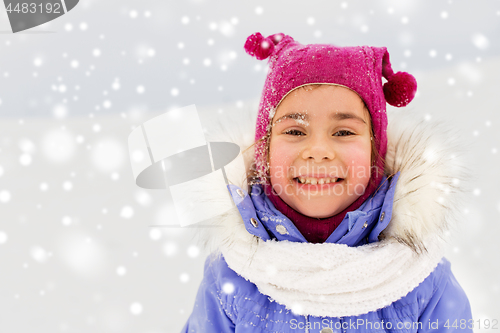 Image of happy little girl in winter clothes outdoors