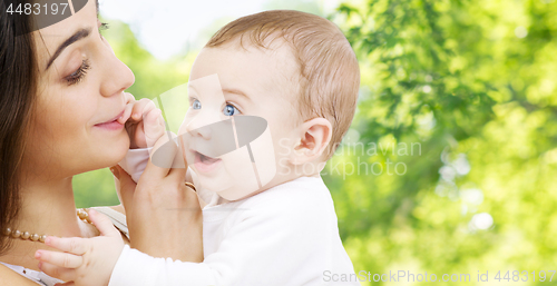 Image of mother with baby over green natural background