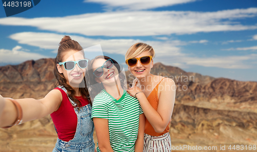 Image of female friends taking selfie over grand canyon