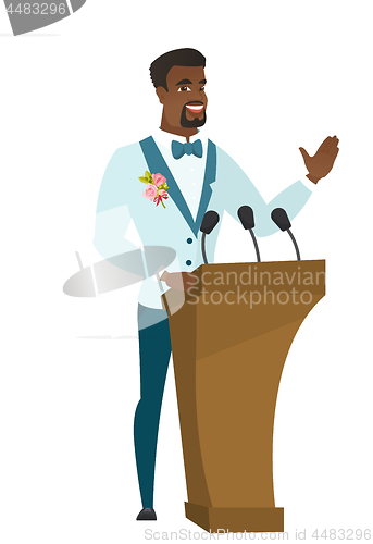 Image of African groom giving a speech from tribune.