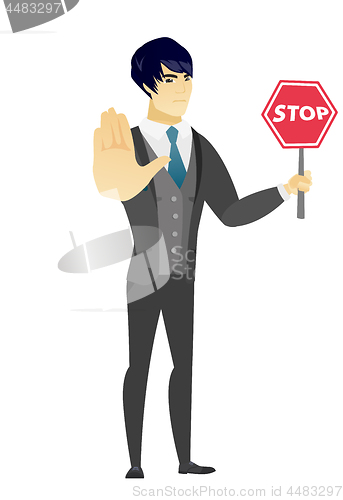 Image of Asian groom holding stop road sign.