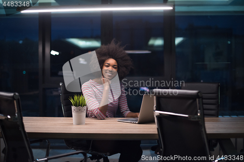 Image of black businesswoman using a laptop in startup office