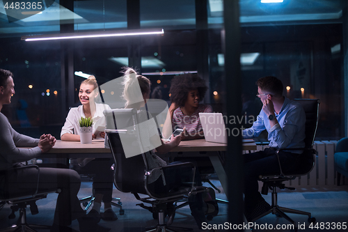 Image of Multiethnic startup business team in night office