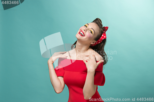 Image of Beautiful young woman with pinup make-up and hairstyle. Studio shot on white background