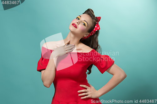 Image of Beautiful young woman with pinup make-up and hairstyle. Studio shot on white background