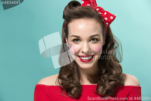 Image of Beautiful young woman with pinup make-up and hairstyle. Studio shot on white background