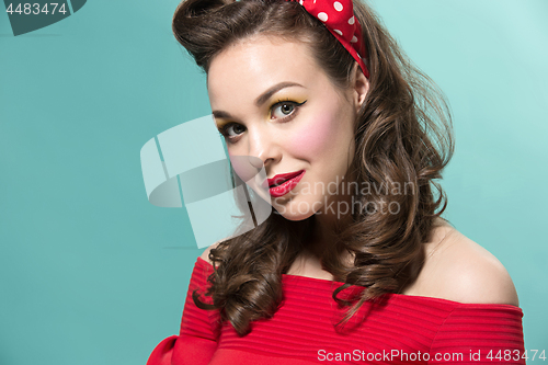 Image of Beautiful young woman with pinup make-up and hairstyle. Studio shot on white background