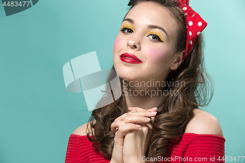 Image of Beautiful young woman with pinup make-up and hairstyle. Studio shot on white background