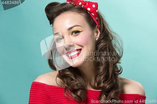 Image of Beautiful young woman with pinup make-up and hairstyle. Studio shot on white background