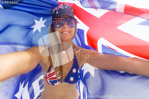 Image of Proudly Australian - Cheerful woman with Australian Flag