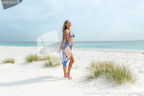 Image of Aussie woman basking sunshine beach lover