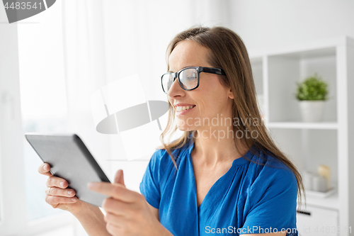 Image of woman with tablet pc working at home or office