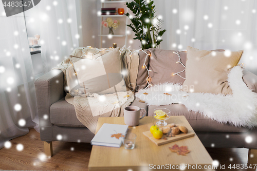 Image of cozy home decorated for christmas over snow