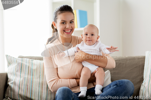 Image of happy mother with little baby boy at home