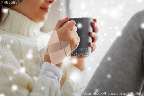 Image of close up of girl in winter sweater with cacao mug