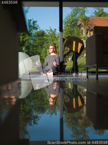 Image of young woman doing morning yoga exercises