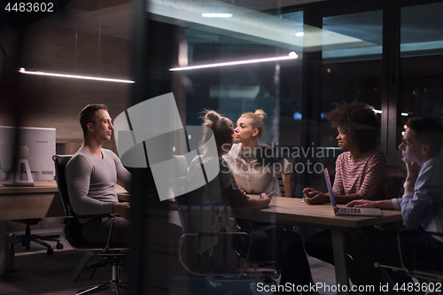 Image of Multiethnic startup business team in night office