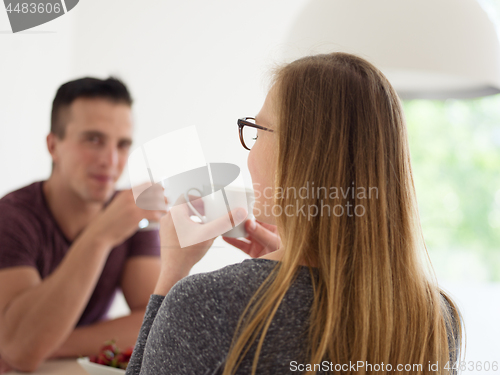 Image of couple enjoying morning coffee and strawberries