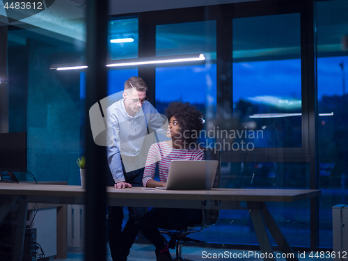 Image of Multiethnic startup business team in night office