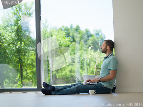 Image of man drinking coffee on the floor enjoying relaxing lifestyle