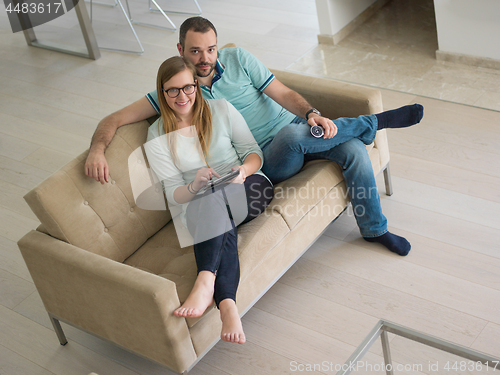 Image of couple relaxes in the living room