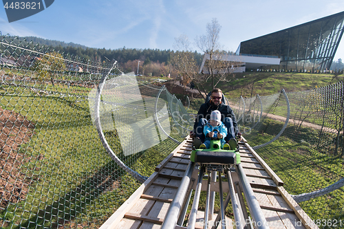 Image of father and son enjoys driving on alpine coaster