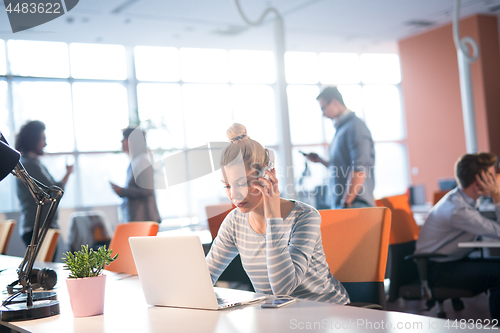 Image of businesswoman using a laptop in startup office