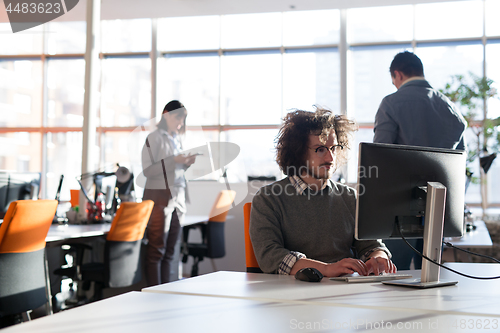 Image of businessman working using a computer in startup office