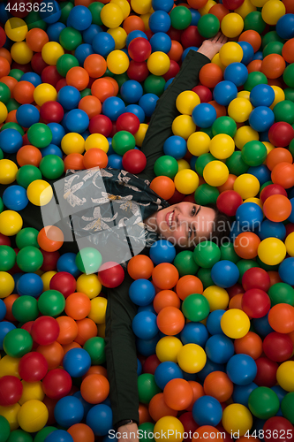 Image of Young mom with her kids in a children\'s playroom