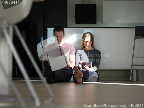 Image of couple using tablet and laptop computers