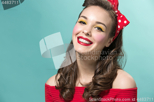 Image of Beautiful young woman with pinup make-up and hairstyle. Studio shot on white background