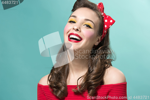 Image of Beautiful young woman with pinup make-up and hairstyle. Studio shot on white background