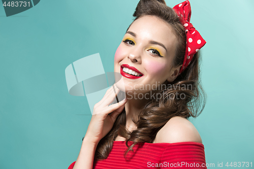 Image of Beautiful young woman with pinup make-up and hairstyle. Studio shot on white background