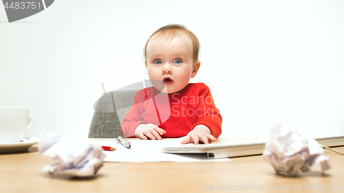 Image of Happy child baby girl toddler sitting with keyboard of computer isolated on a white background