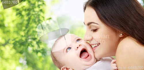 Image of mother with baby over green natural background