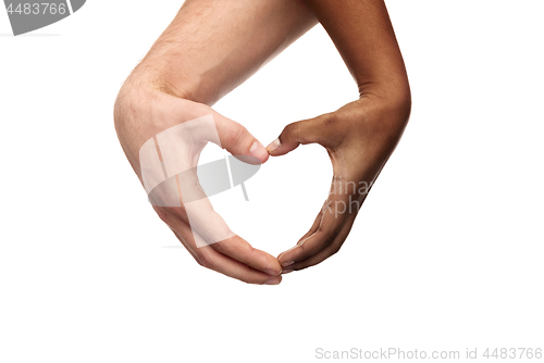 Image of hands of different skin color making heart shape