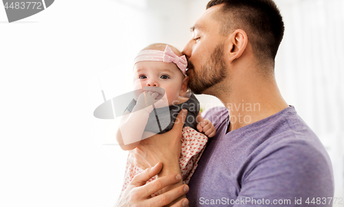 Image of close up of father kissing little baby daughter